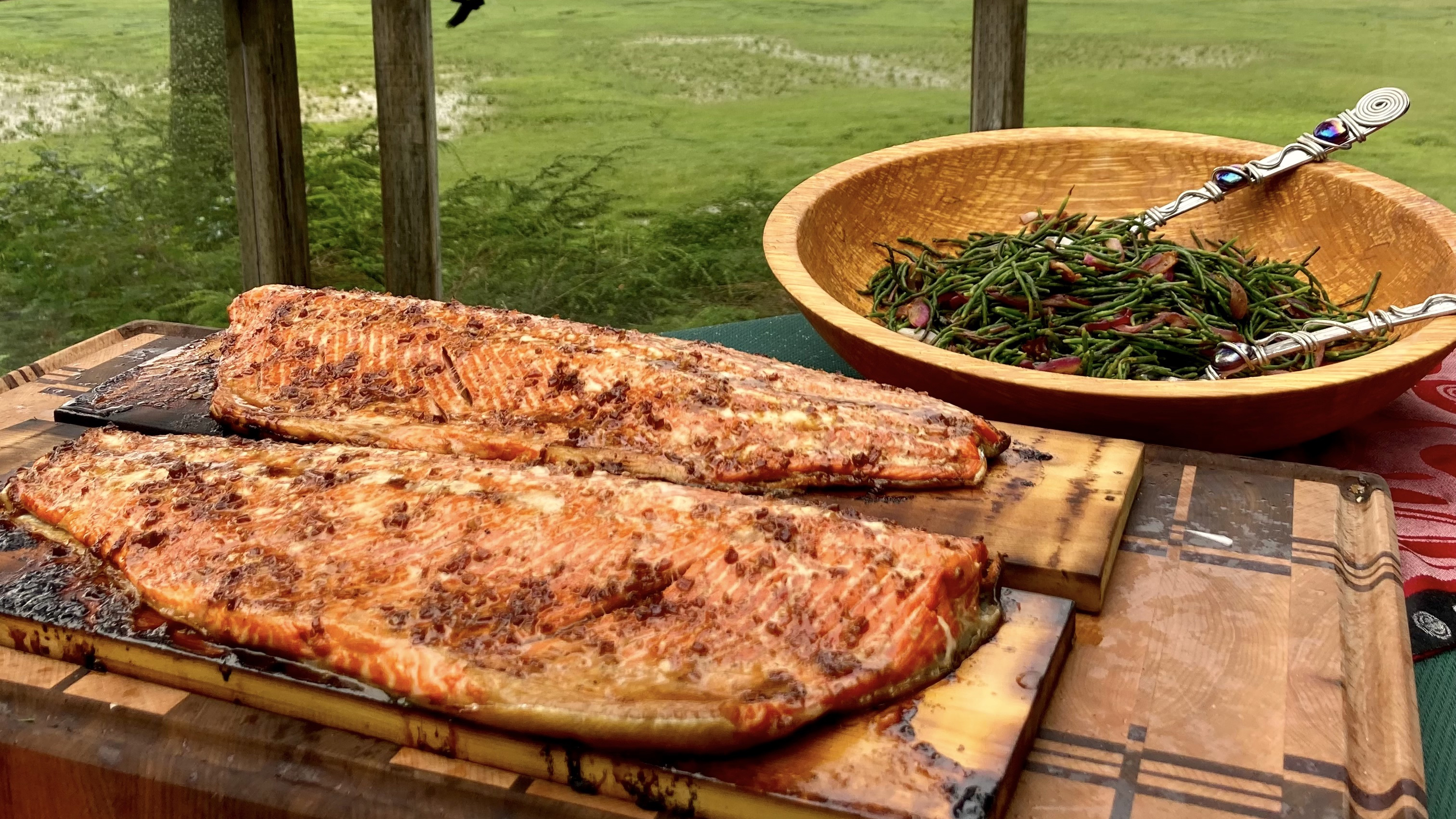 Cedar planked salmon with sea asaparagus, bacon and onions